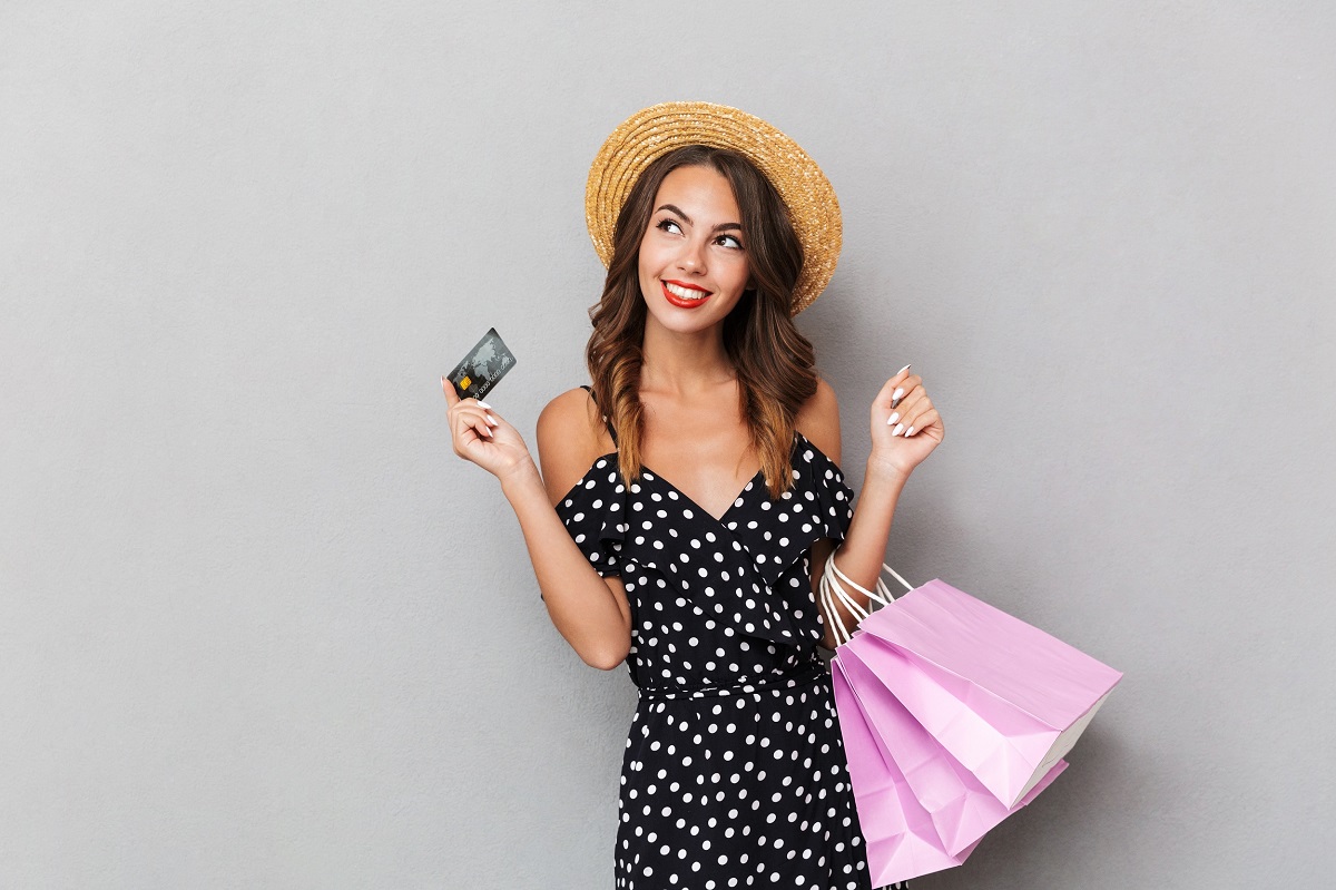 happy girl with shopping bags and credit shopping with coupons in Australia