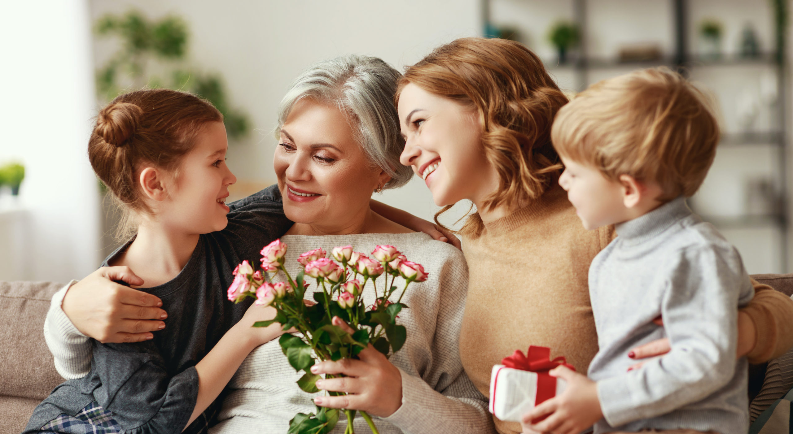 Grandmother Mother and children with flowers and gift