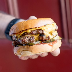 Person holding a Burger from Burgerhood. Best Burgers in Sydney List